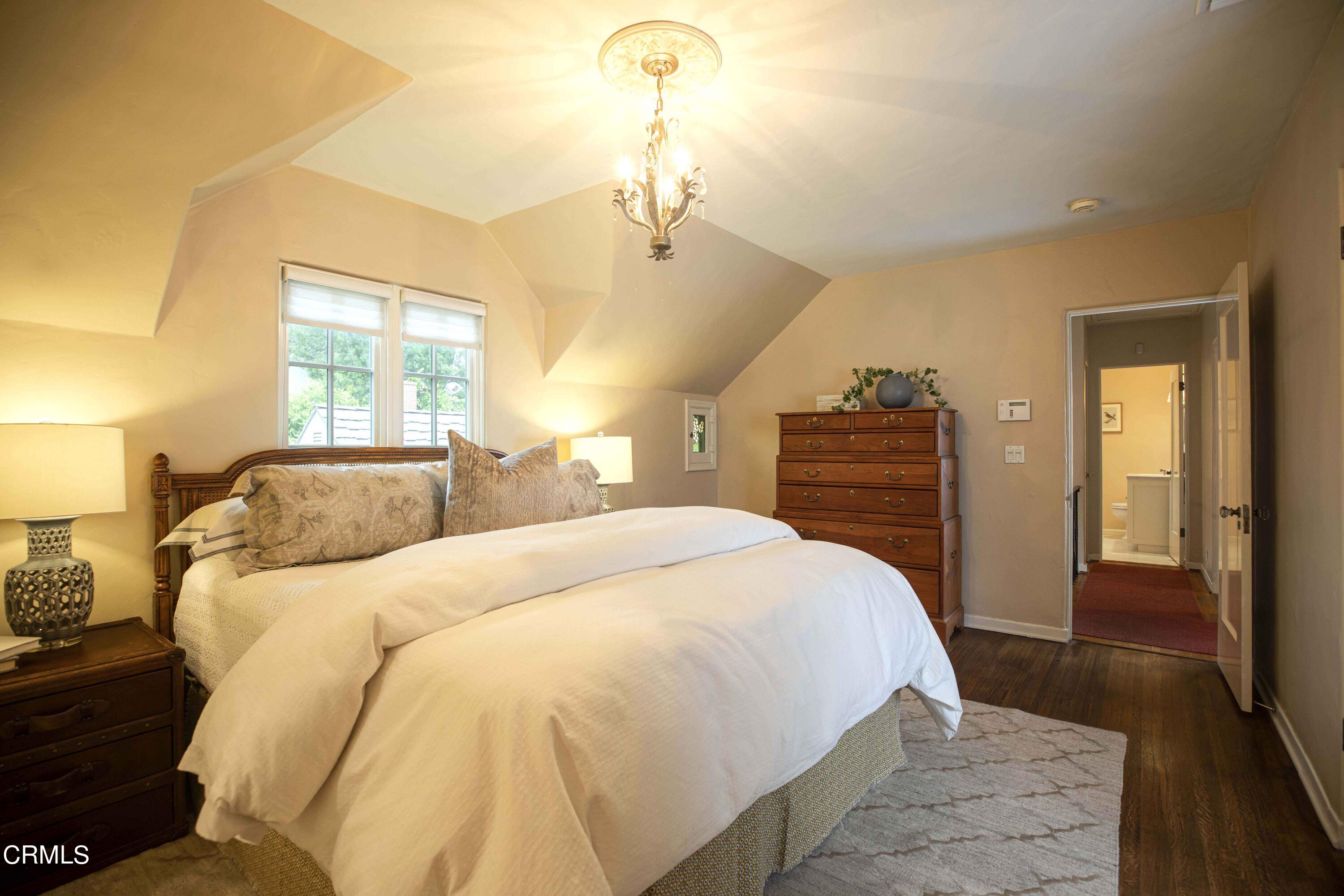 Undisclosed Address Pasadena, CA 91106 - Photo 22 of 40 a spacious bedroom with a bed and wooden floor