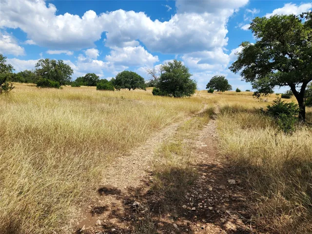 a view of a lake with houses in back