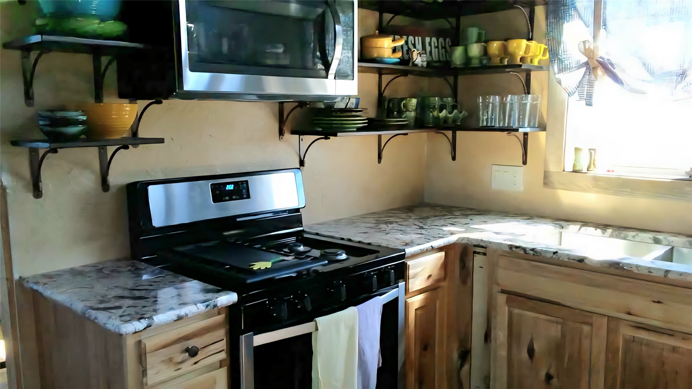 1332 Short Road Vanderpool, TX 78885 - Photo 34 of 44 a kitchen with stainless steel appliances granite countertop a stove and a sink