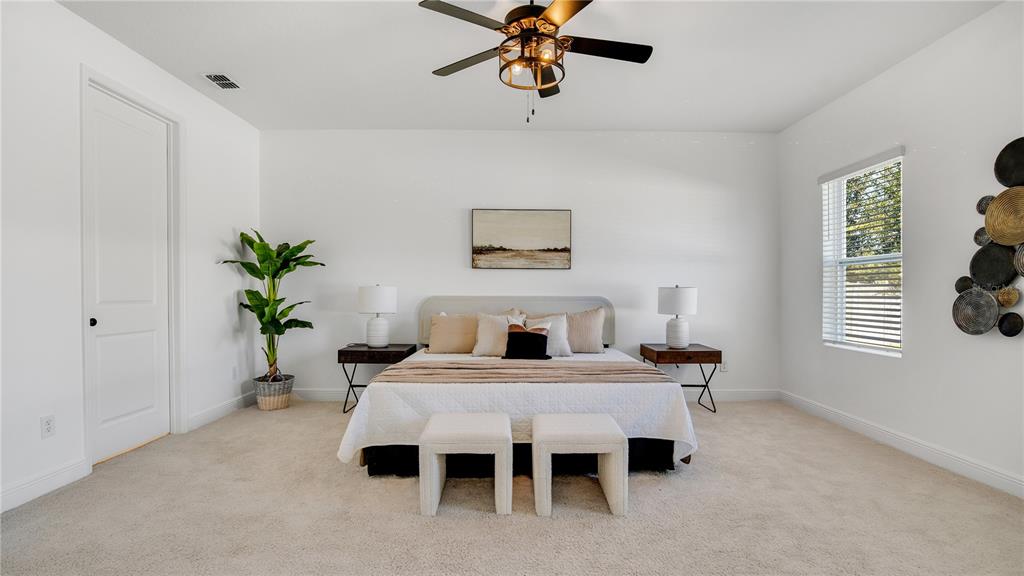 1108 Pearl Tree Road Deltona, FL 32725 - Photo 13 of 37 a bedroom with a bed and a table