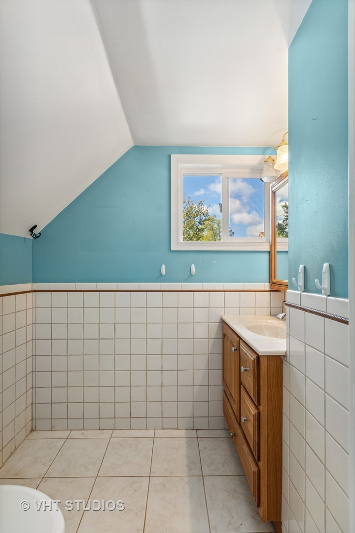 1200 Bayview Road Fox River Grove, IL 60021 - Photo 12 of 21 a bathroom with a sink a vanity and a shower
