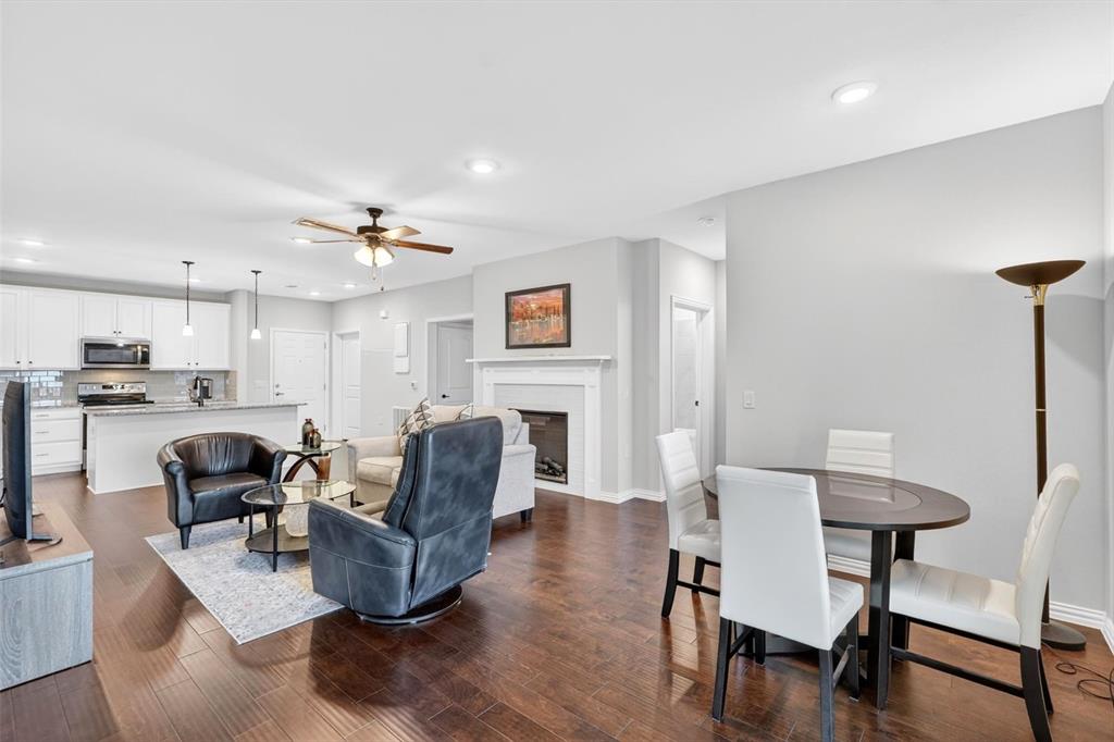 651 Watters Road, Unit 5305 Allen, TX 75013 - Photo 3 of 40 a living room with fireplace furniture and a wooden floor