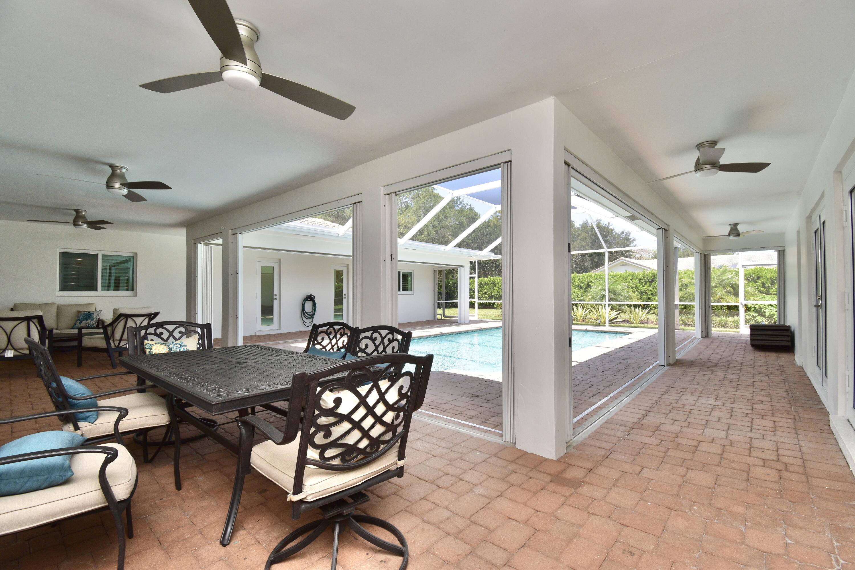 20954 Cipres Way Boca Raton, FL 33433 - Photo 58 of 65 a dining room with furniture large windows and wooden floor
