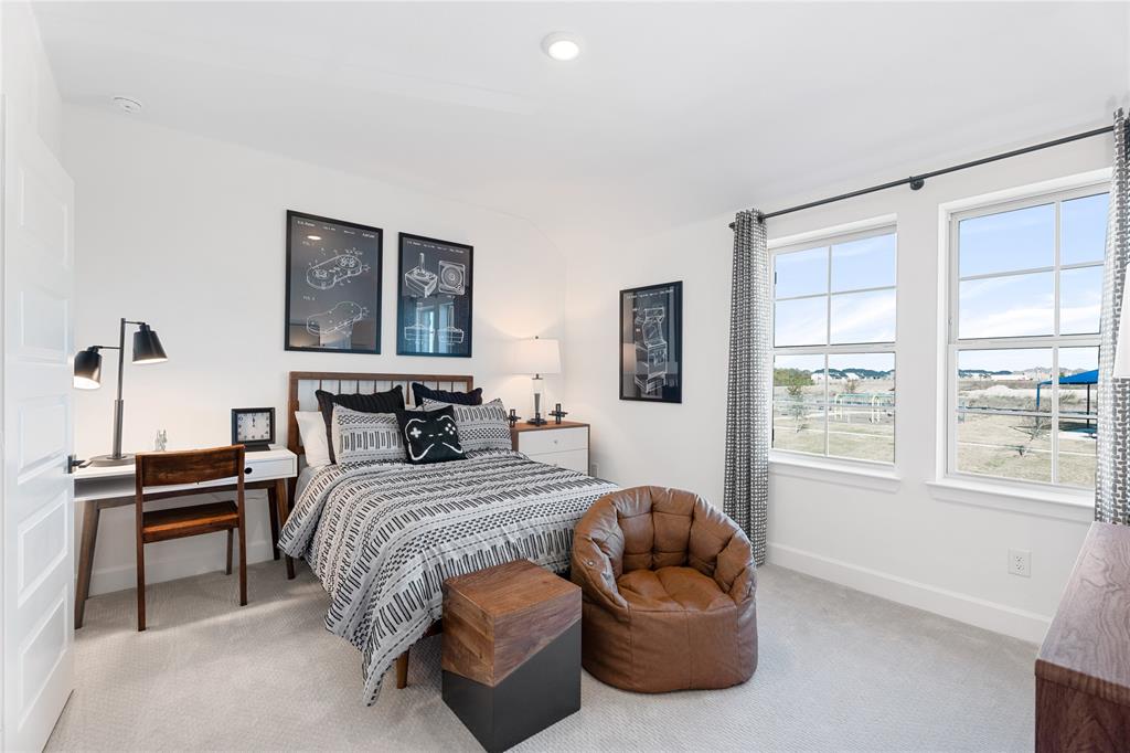 813 Anthem Lane Forney, TX 75126 - Photo 17 of 21 a bedroom with a bed and a window