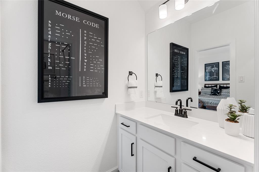 813 Anthem Lane Forney, TX 75126 - Photo 19 of 21 a bathroom with a sink a vanity and mirror
