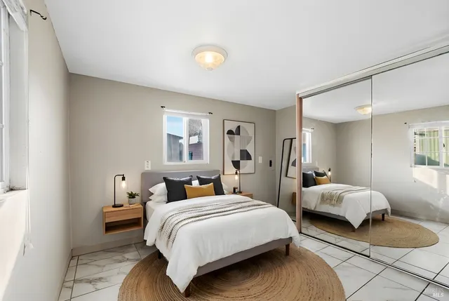 a bedroom with two beds and a window