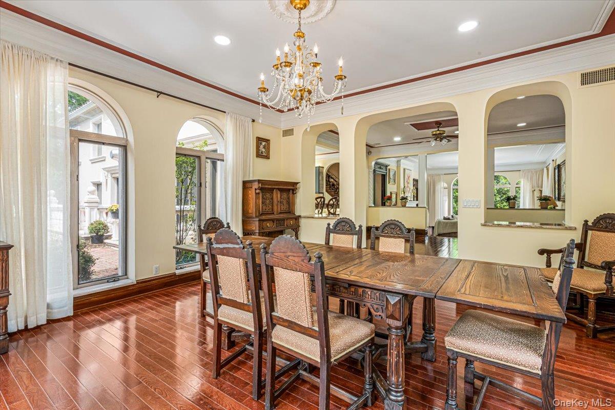 952 Cedar Swamp Road Glen Head, NY 11545 - Photo 13 of 50 a view of a dining room with furniture wooden floor and chandelier