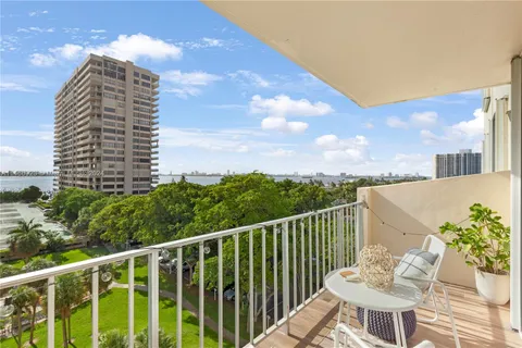 a view of a balcony with two chairs