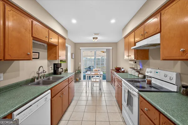 a kitchen with stainless steel appliances granite countertop a sink and cabinets