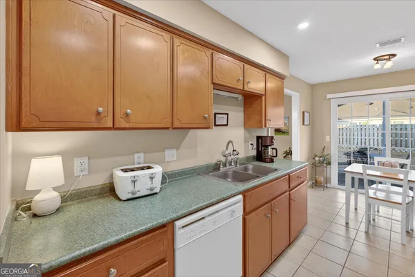a kitchen with a sink a stove and cabinets