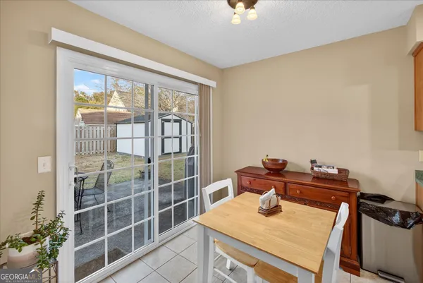 a bedroom with a bed and a flat tv screen on dresser