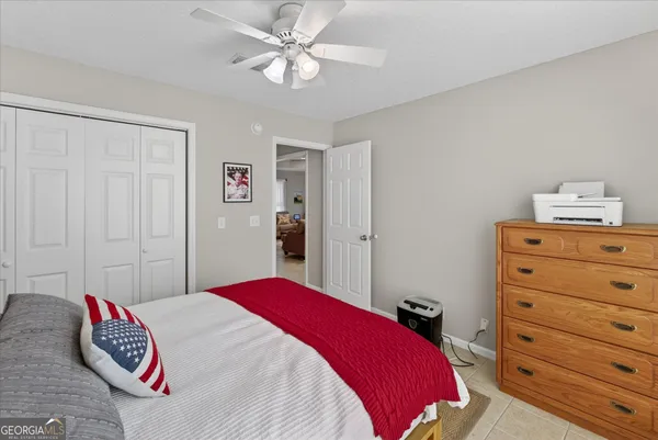 a bedroom with a bed and a table with chair