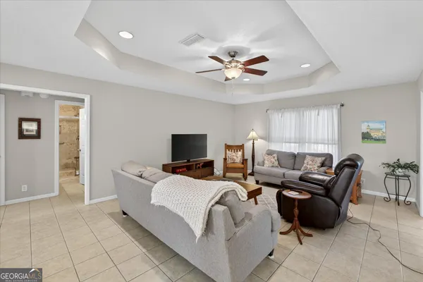 a living room with furniture and a chandelier