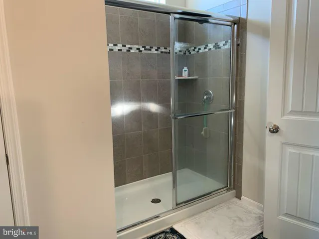 a bathroom with a glass shower door