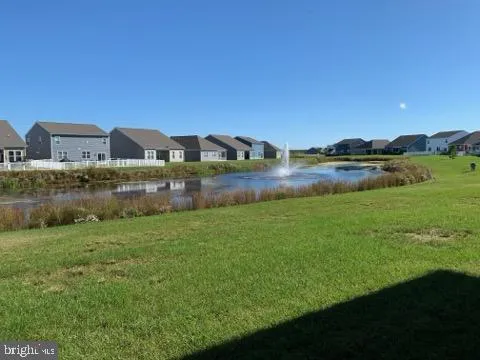 a view of a lake with a field in the back