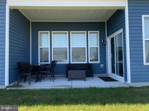 a house view with outdoor seating space and garden