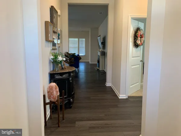 a hallway with a dining table chairs and entryway