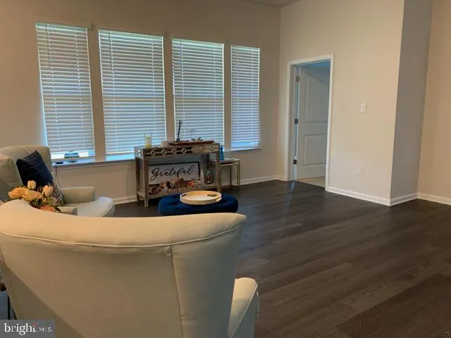 a living room with furniture and two window