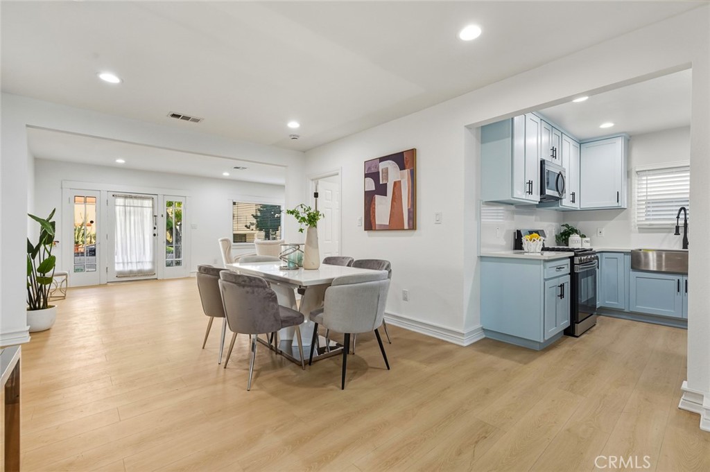 1065 Bennett Avenue Long Beach, CA 90804 - Photo 10 of 44 a kitchen with stainless steel appliances kitchen island granite countertop a sink and cabinets