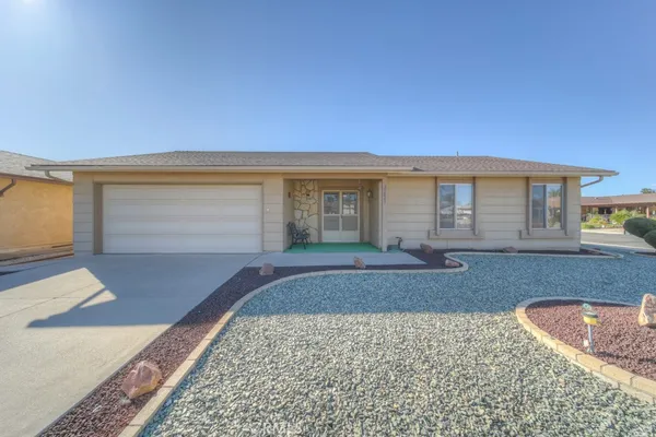 a view of a house with a backyard