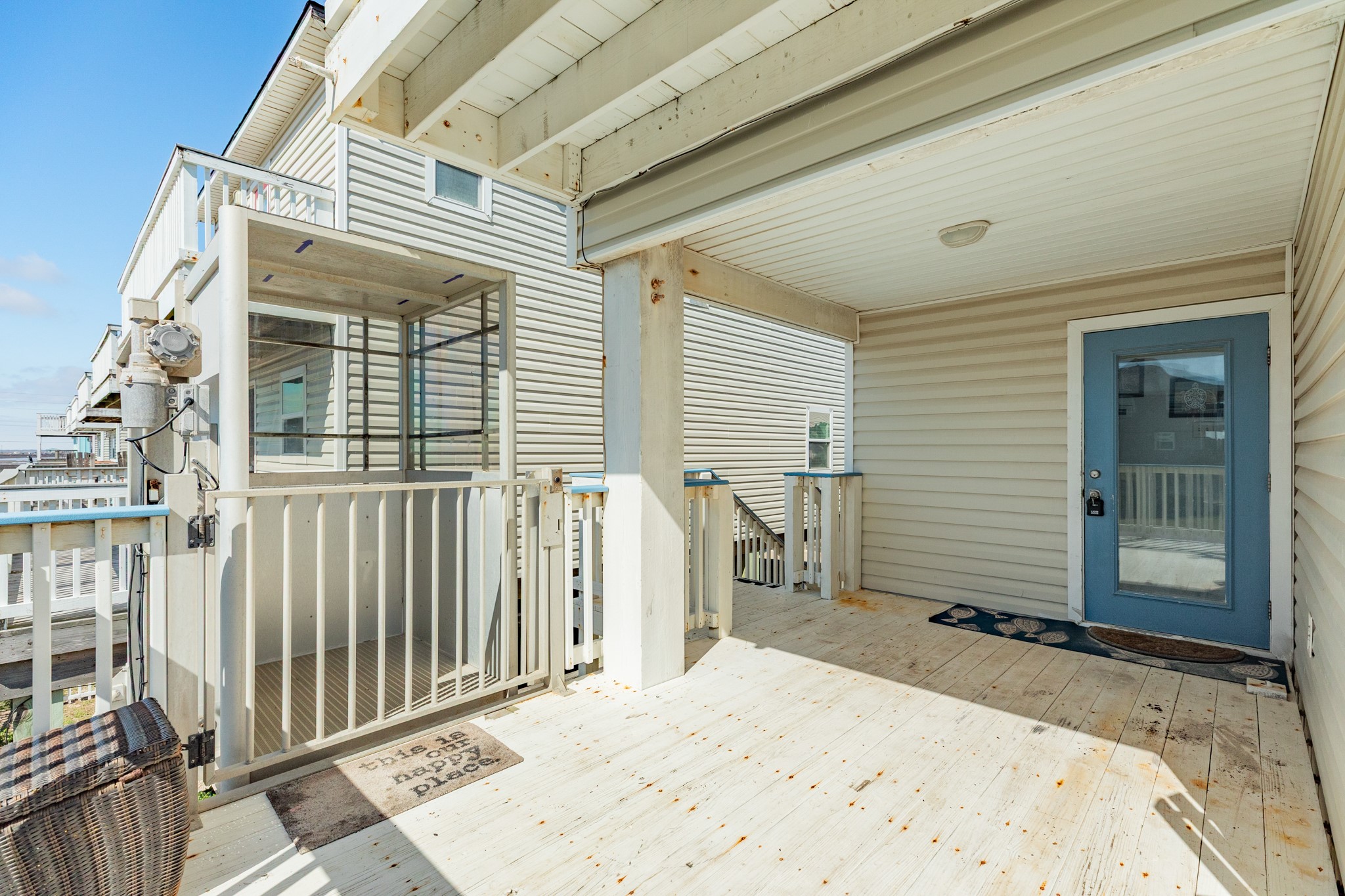 107 Howard Avenue Surfside Beach, TX 77541 - Photo 12 of 38 Welcoming covered balcony with private entry door and ample space for outdoor seating, offering a comfortable spot to enjoy coastal breezes.