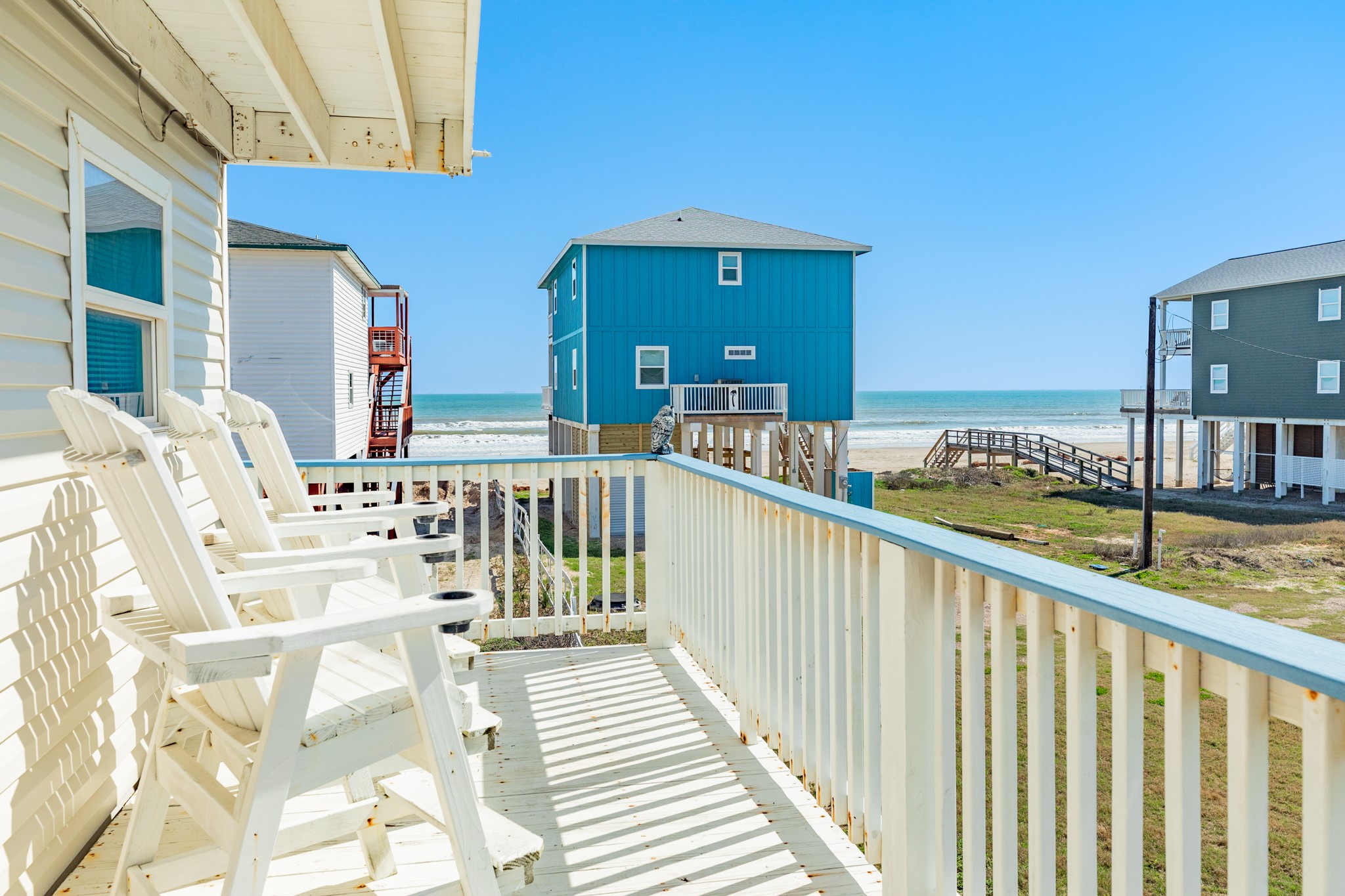 107 Howard Avenue Surfside Beach, TX 77541 - Photo 14 of 38 Enjoy partial Gulf views from the upper balcony, providing a peaceful vantage point to take in the sights and sounds of the shoreline.