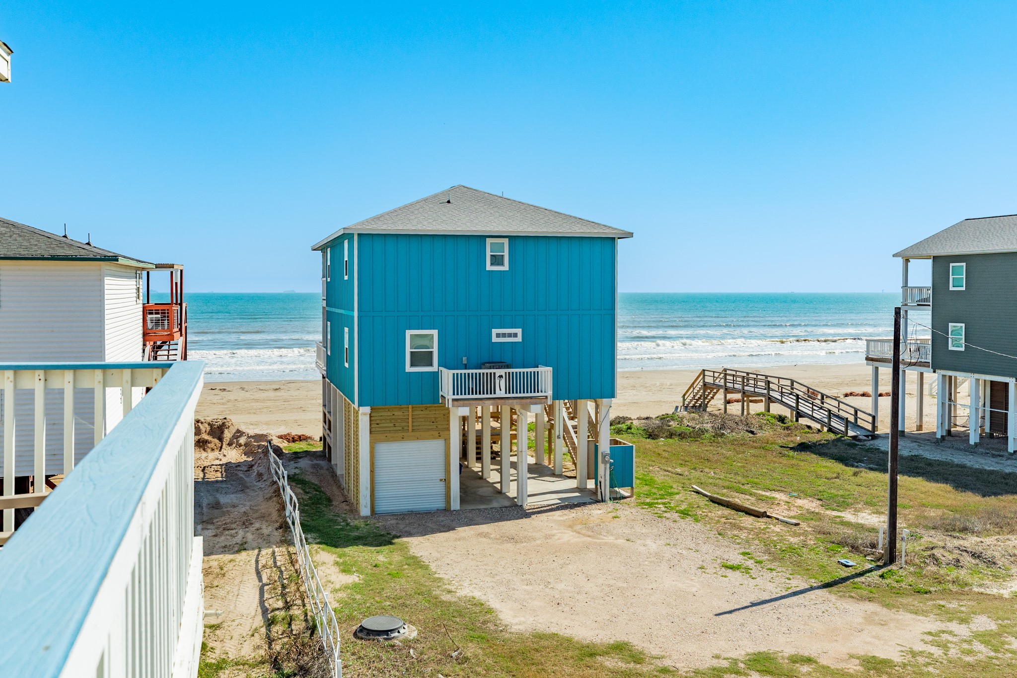107 Howard Avenue Surfside Beach, TX 77541 - Photo 16 of 38 Relaxing upper-level balcony with seating area positioned to capture refreshing sea breezes and scenic views.