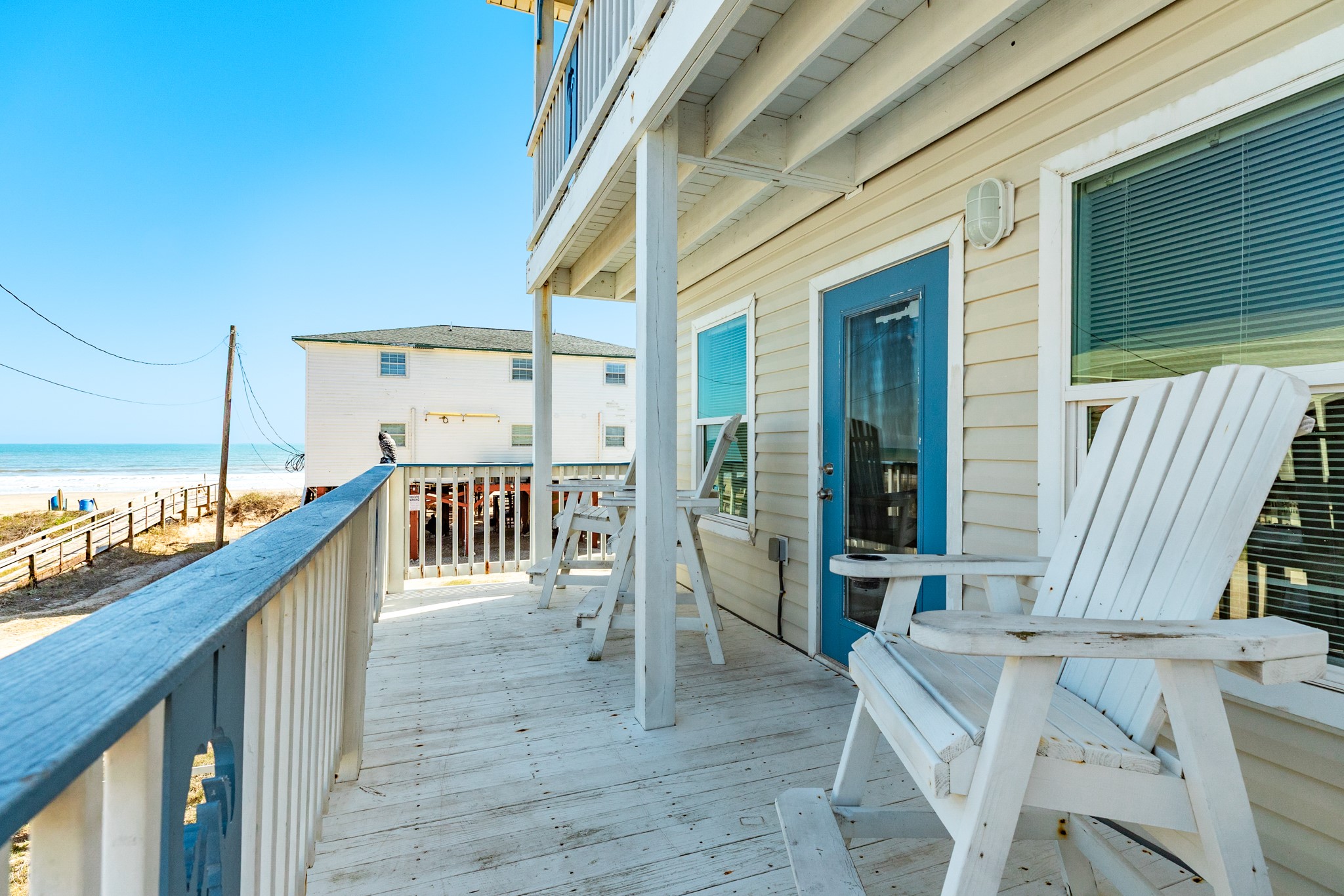 107 Howard Avenue Surfside Beach, TX 77541 - Photo 17 of 38 Covered outdoor retreat with multiple seating options, ideal for gathering or unwinding after a day on the beach.