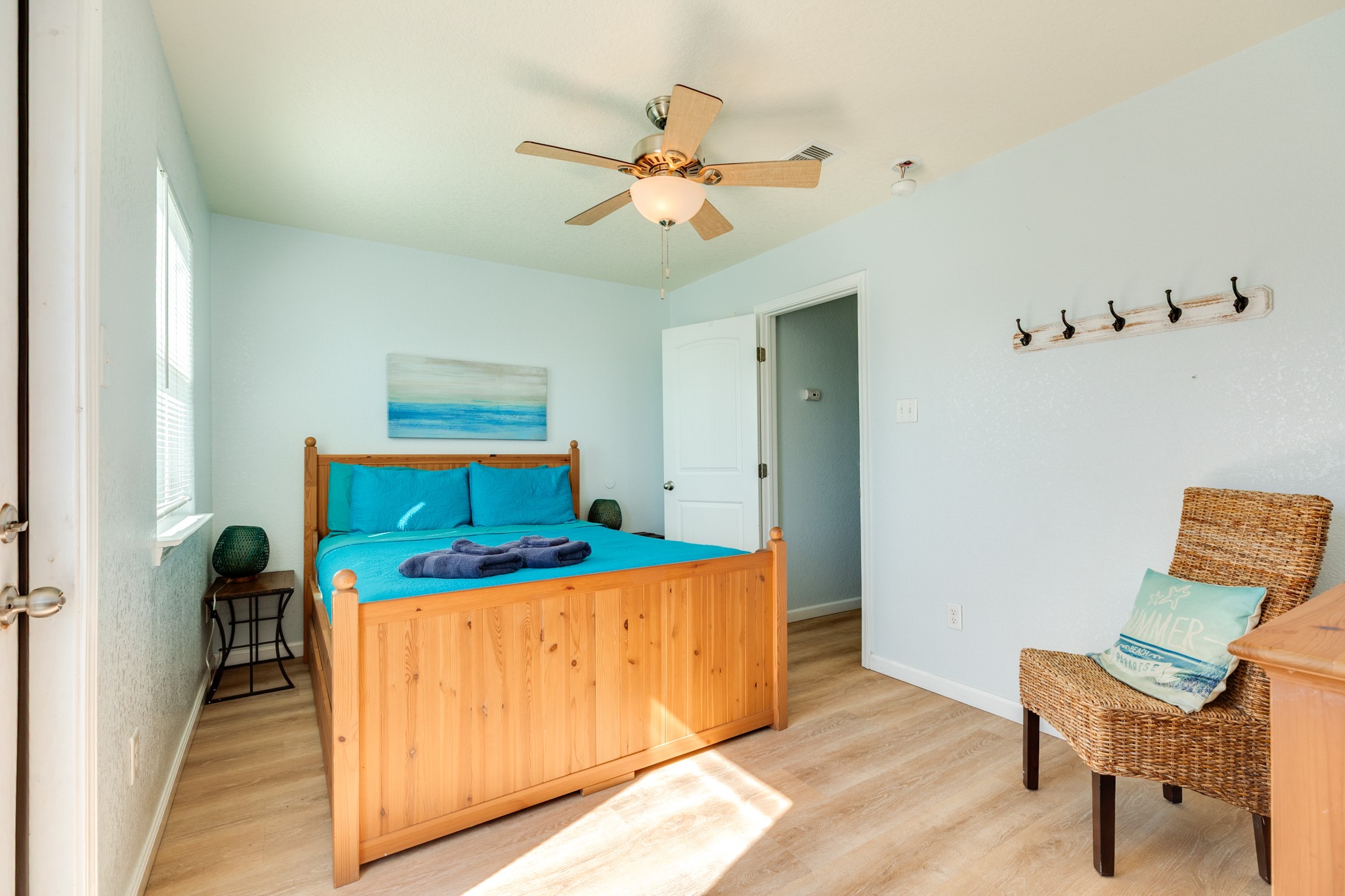 107 Howard Avenue Surfside Beach, TX 77541 - Photo 30 of 38 Comfortable secondary bedroom with warm wood furnishings, vibrant bedding, and ample natural light.