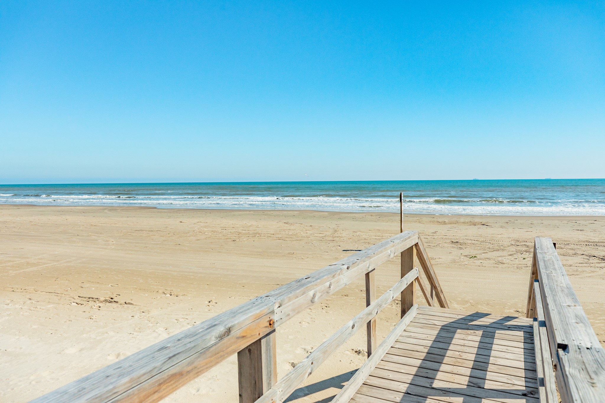107 Howard Avenue Surfside Beach, TX 77541 - Photo 7 of 38 Expansive beach and Gulf views just steps from the home, offering a true coastal living experience.