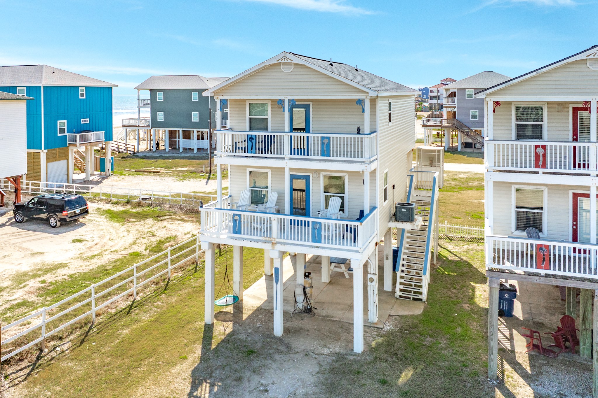 107 Howard Avenue Surfside Beach, TX 77541 - Photo 8 of 38 Two-story beach retreat featuring spacious upper and lower decks, perfect for enjoying coastal breezes and outdoor relaxation.