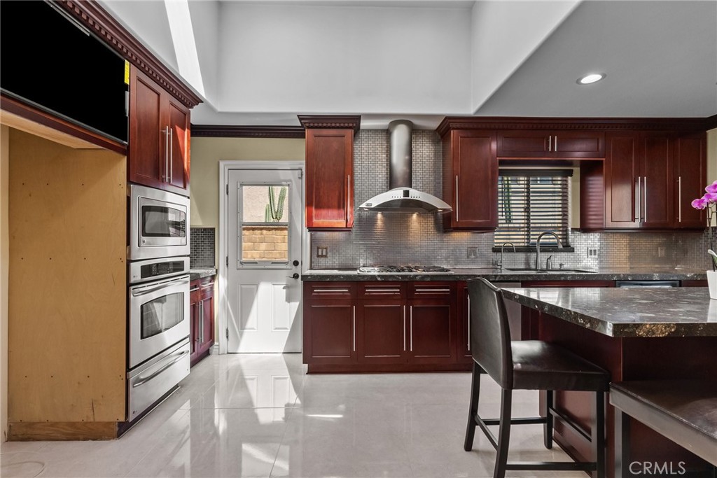 931 University Avenue Burbank, CA 91504 - Photo 17 of 49 a kitchen with granite countertop stainless steel appliances and wooden cabinets