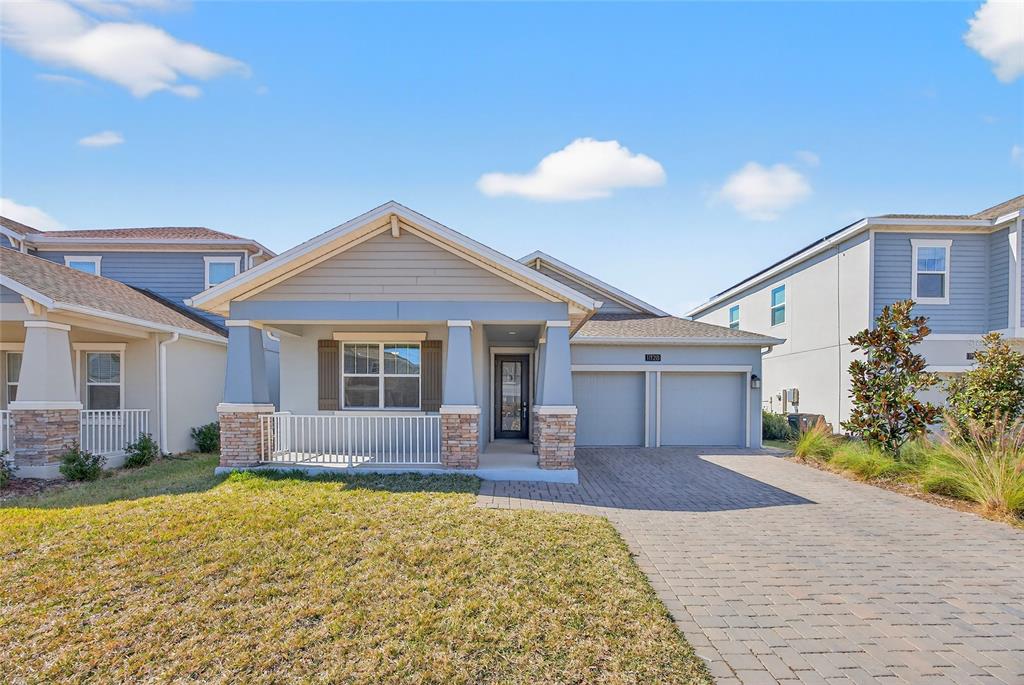 11128 Lore Way Orlando, FL 32832 - Photo 1 of 79 a front view of a house with a yard and outdoor seating