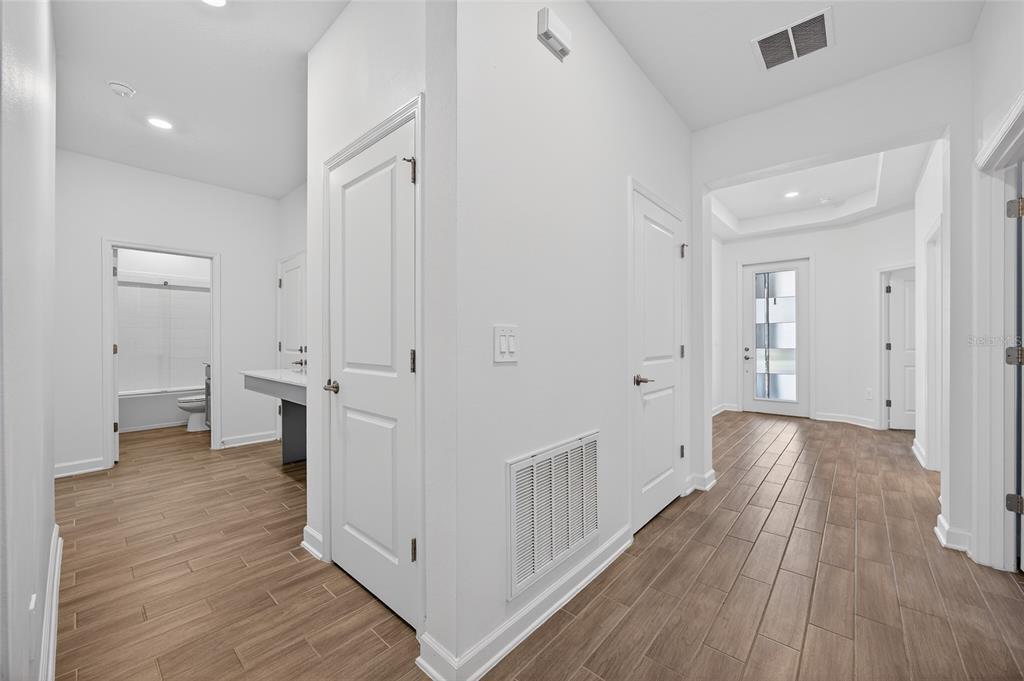 11128 Lore Way Orlando, FL 32832 - Photo 19 of 79 a view of a hallway with wooden floor and closet