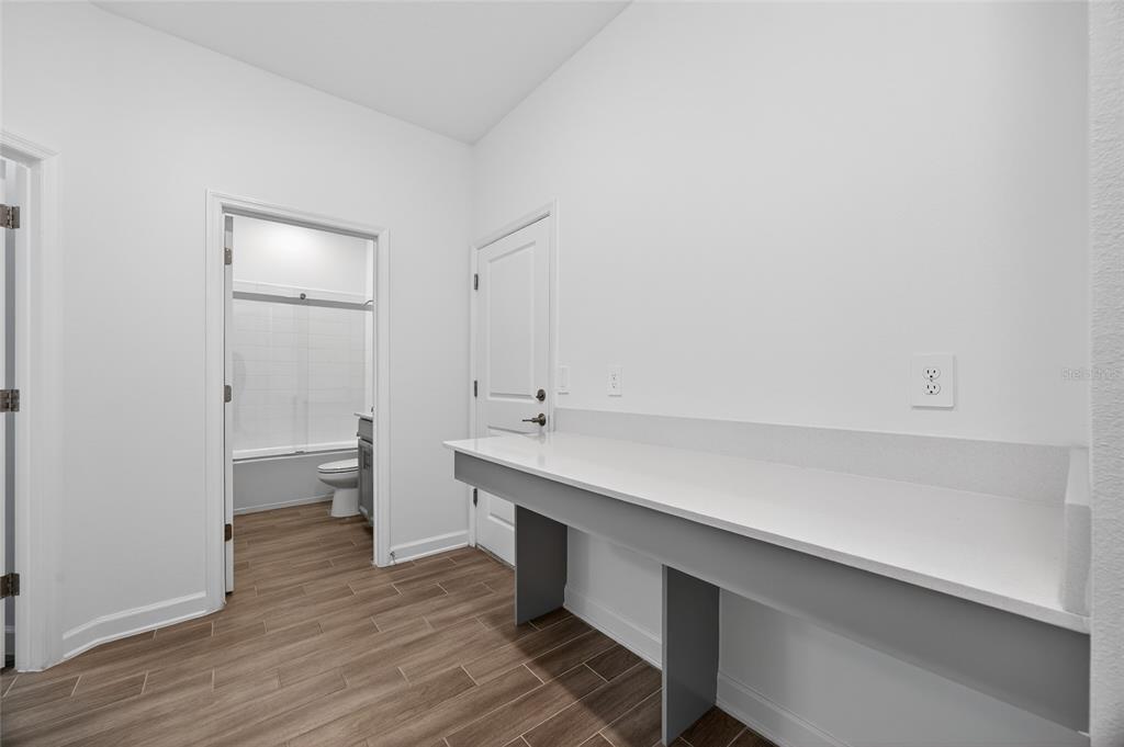 11128 Lore Way Orlando, FL 32832 - Photo 20 of 79 a room with a wooden floor and white walls