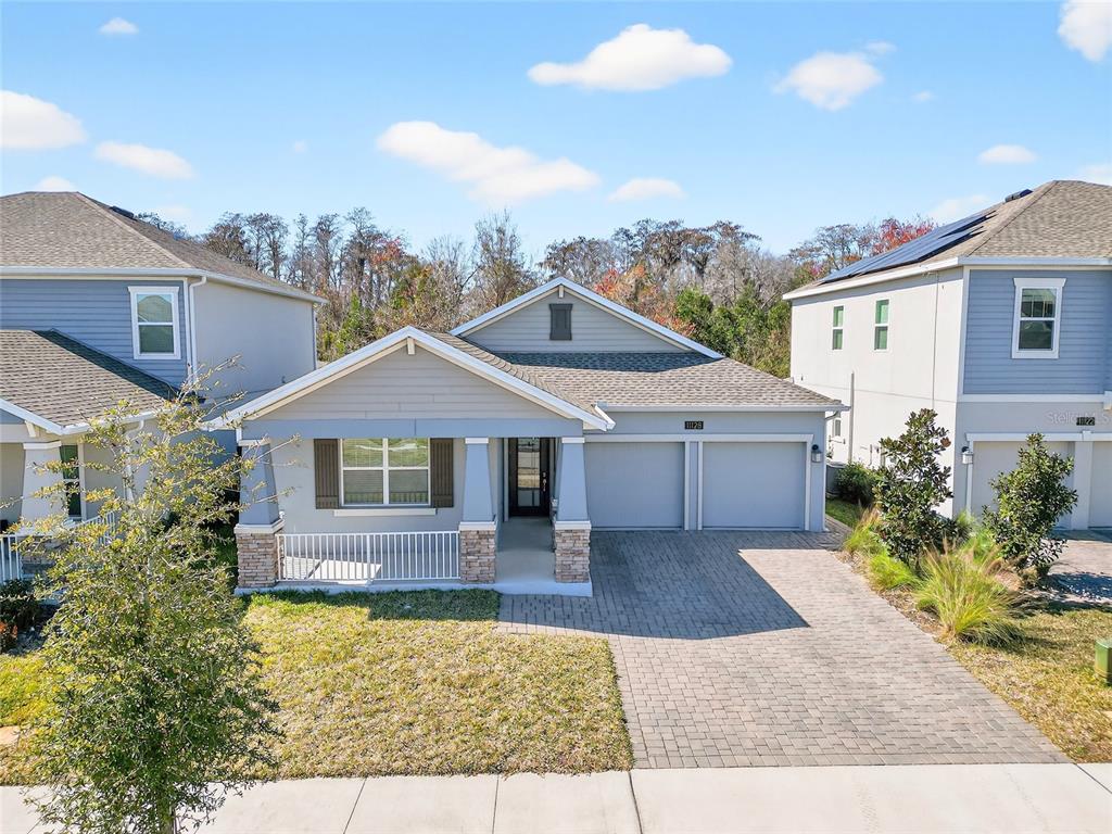 11128 Lore Way Orlando, FL 32832 - Photo 2 of 79 a front view of house with yard and trees in the background