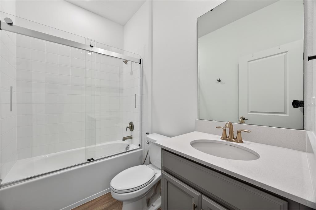 11128 Lore Way Orlando, FL 32832 - Photo 22 of 79 a bathroom with a sink toilet and shower