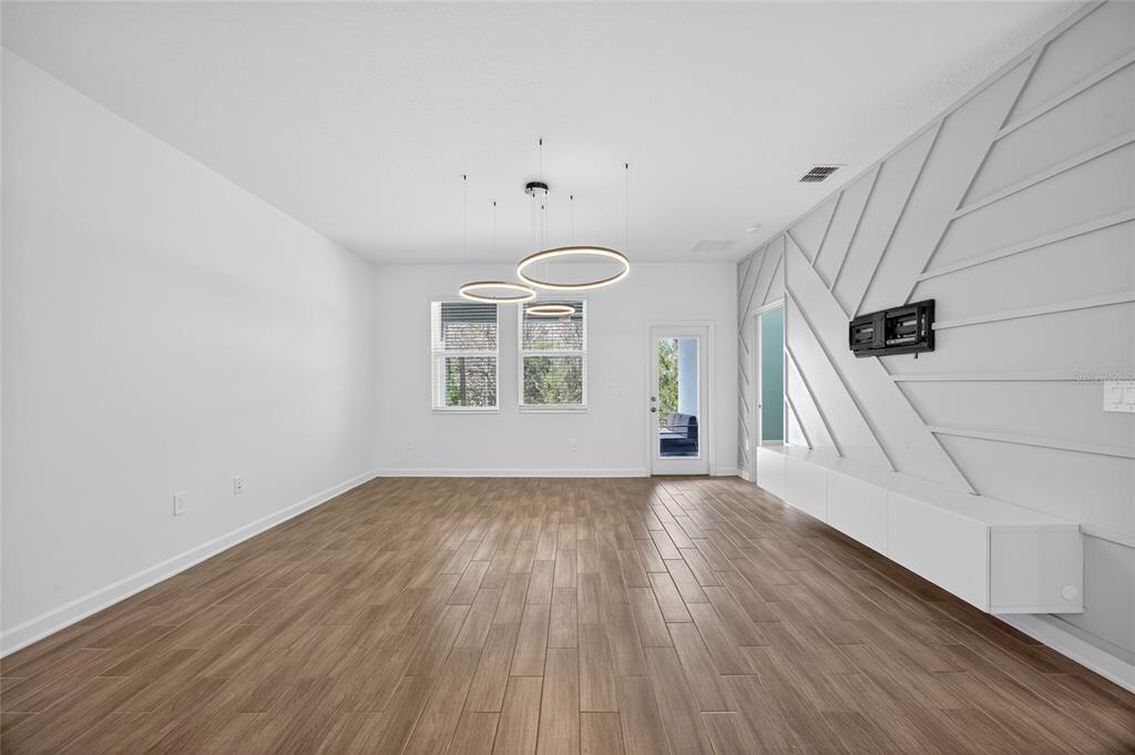 11128 Lore Way Orlando, FL 32832 - Photo 27 of 79 an empty room with wooden floor fan and windows
