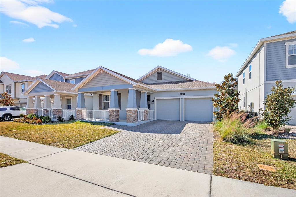 11128 Lore Way Orlando, FL 32832 - Photo 3 of 79 a front view of a house with garden