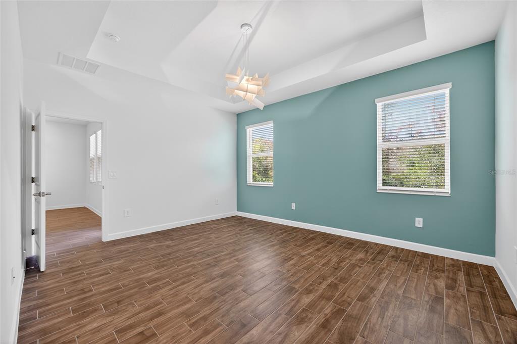 11128 Lore Way Orlando, FL 32832 - Photo 32 of 79 a view of an empty room with wooden floor and a window