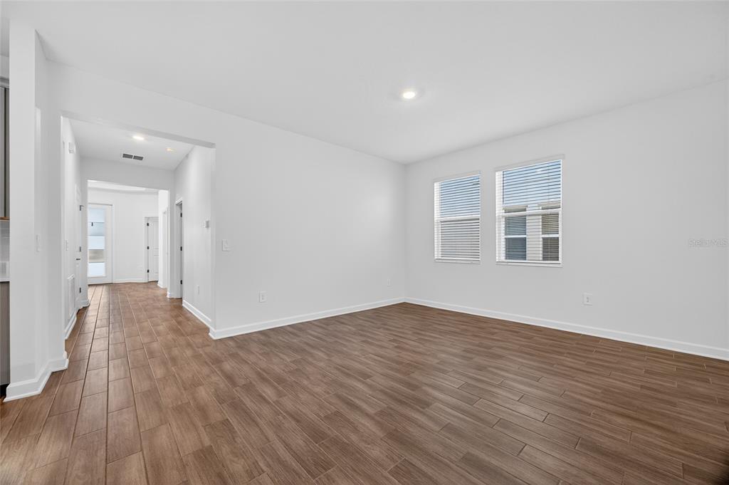11128 Lore Way Orlando, FL 32832 - Photo 33 of 79 a view of an empty room with wooden floor and a window