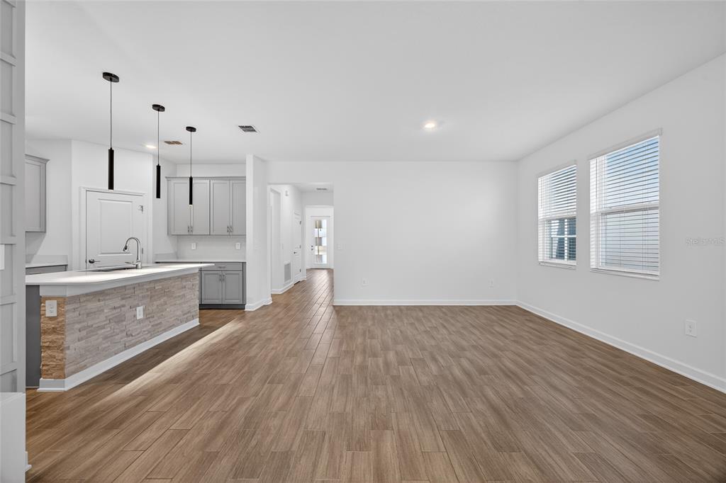 11128 Lore Way Orlando, FL 32832 - Photo 34 of 79 a large kitchen with kitchen island a sink stainless steel appliances and cabinets