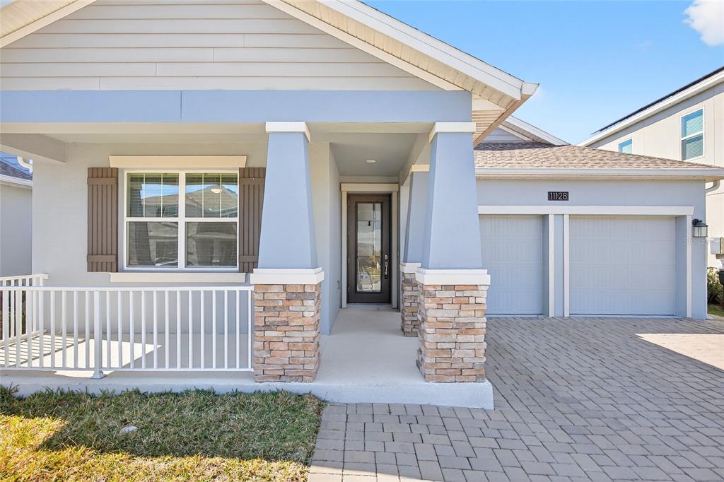 11128 Lore Way Orlando, FL 32832 - Photo 4 of 79 a front view of a house with a yard