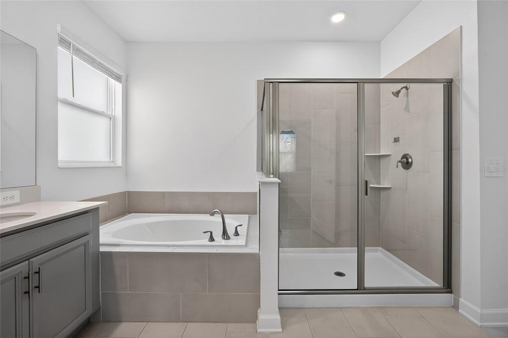 11128 Lore Way Orlando, FL 32832 - Photo 47 of 79 a bathroom with a bathtub and a shower