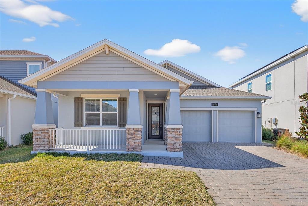 11128 Lore Way Orlando, FL 32832 - Photo 5 of 79 a front view of a house with a yard