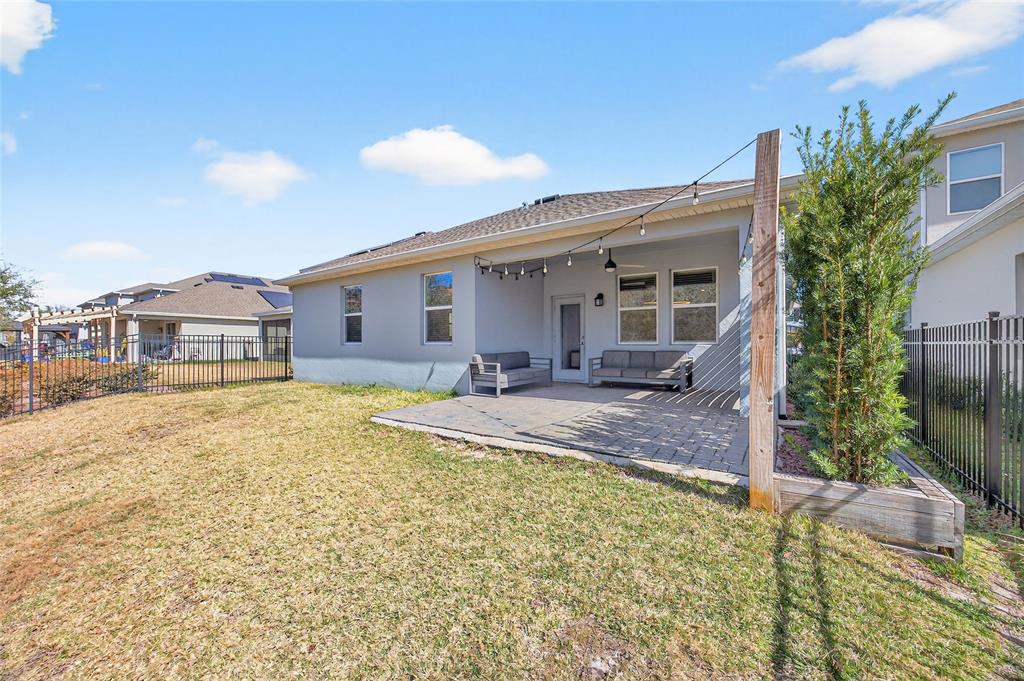 11128 Lore Way Orlando, FL 32832 - Photo 60 of 79 a view of a house with backyard and sitting area