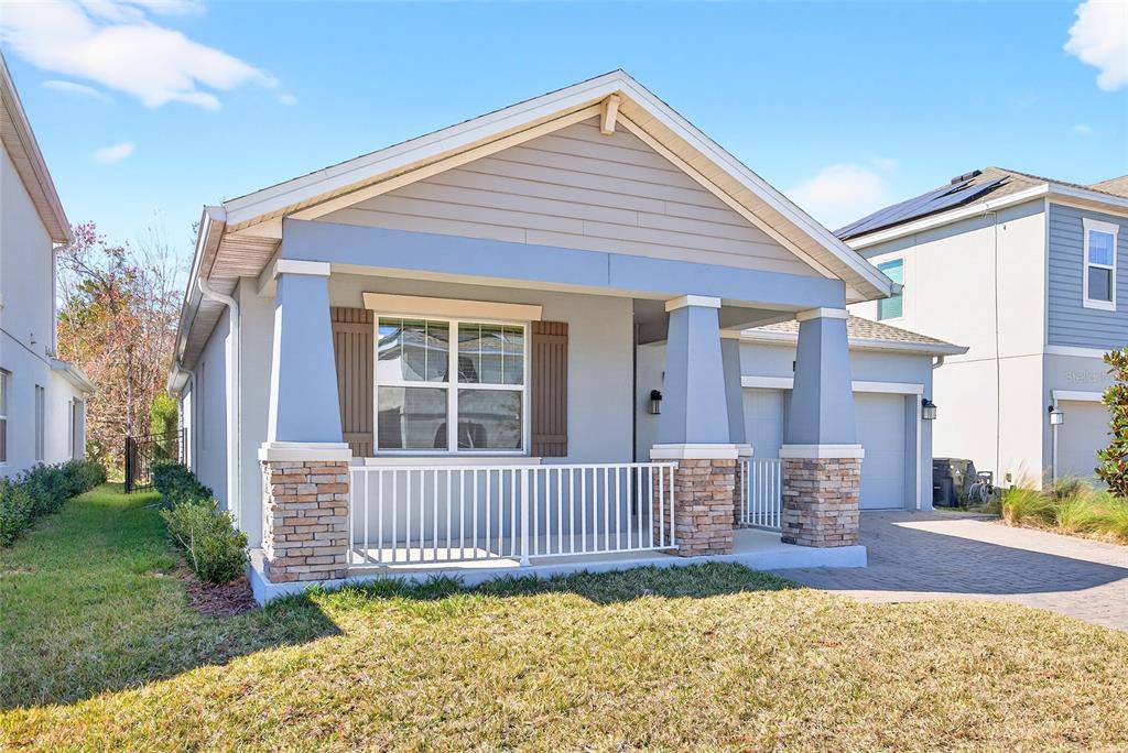 11128 Lore Way Orlando, FL 32832 - Photo 6 of 79 a view of a house with a small yard and a garden