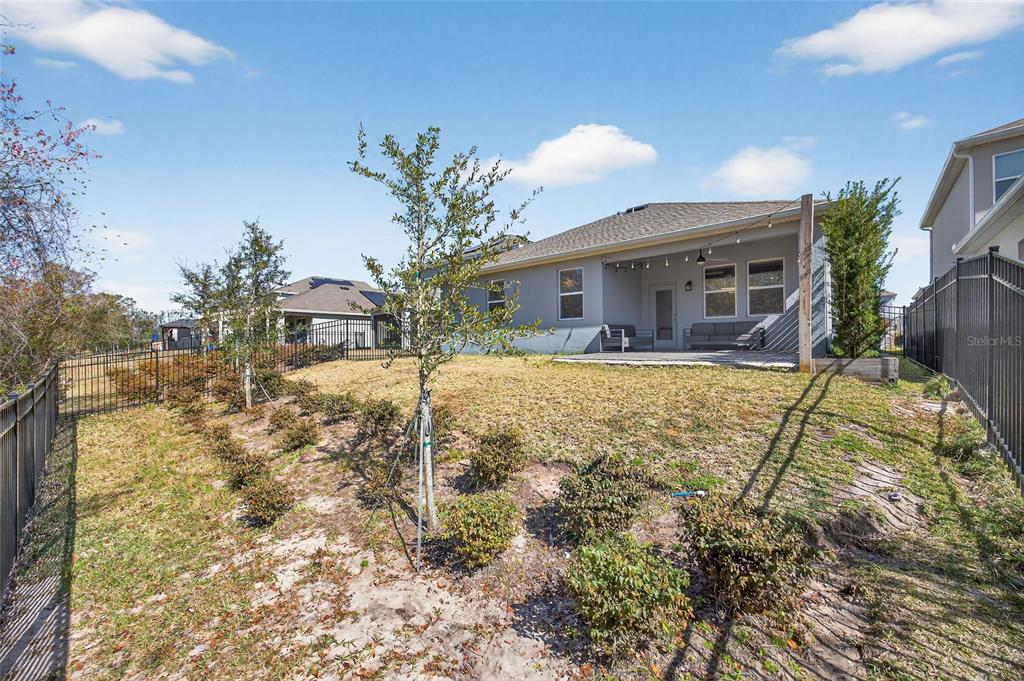 11128 Lore Way Orlando, FL 32832 - Photo 63 of 79 a view of house with a yard