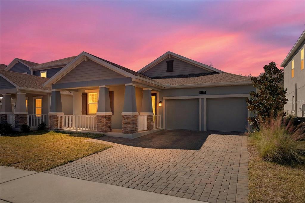 11128 Lore Way Orlando, FL 32832 - Photo 9 of 79 a front view of a house with a yard and garage