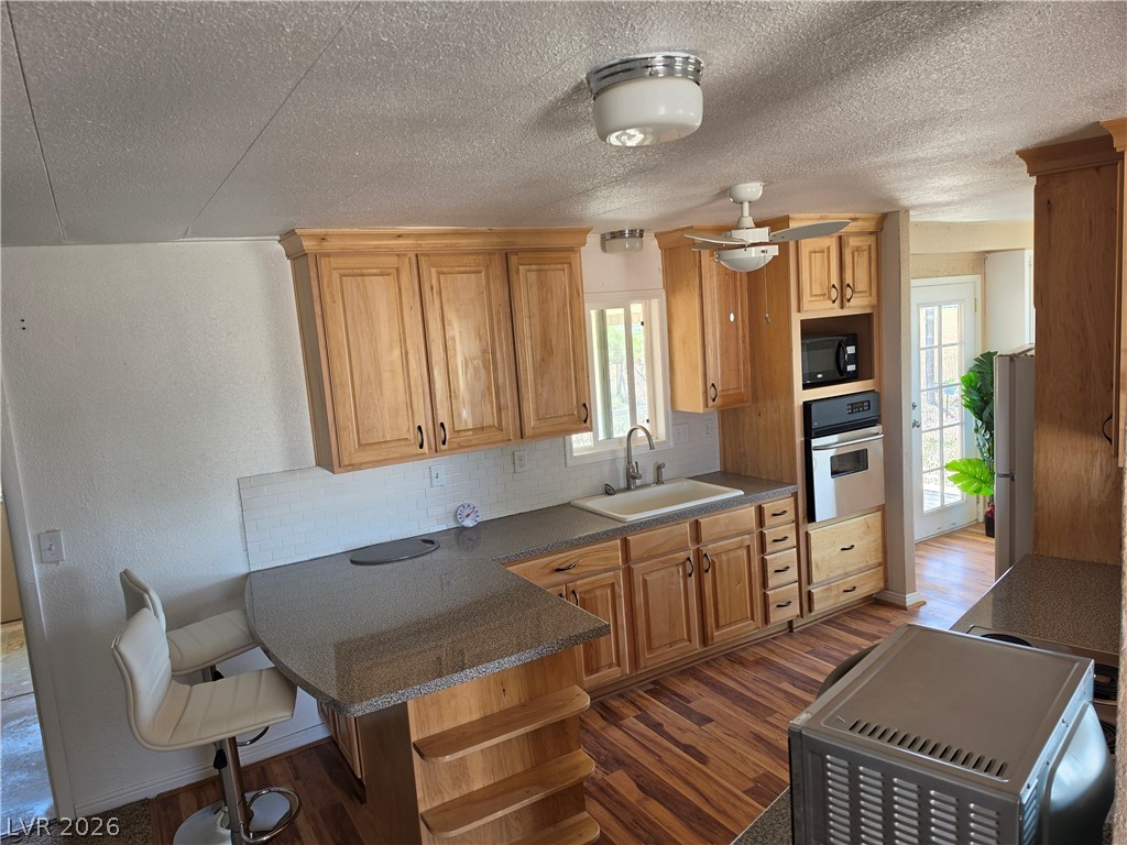 2930 Frehner Ranch Road Pioche, NV 89043 - Photo 34 of 39 A well-equipped kitchen features wooden cabinetry and built-in appliances, perfect for culinary endeavors.